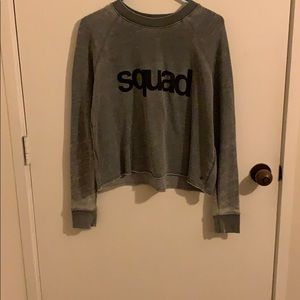Grey cropped sweatshirt. “Squad”